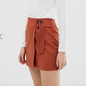 ASOS DESIGN wrap mini skirt with horn buckle